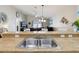 Open concept kitchen with view into living area; featuring stainless steel sink and plenty of counter space at 12306 Ne 48Th Way, Oxford, FL 34484