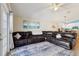 Inviting living area showcasing a large sectional sofa, cozy rug, and a seamless flow to the kitchen at 12306 Ne 48Th Way, Oxford, FL 34484