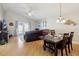 Open-concept living and dining areas with hardwood floors, vaulted ceilings and plenty of natural light at 12306 Ne 48Th Way, Oxford, FL 34484