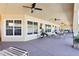 A covered outdoor patio area with tables and chairs, perfect for relaxation at 12306 Ne 48Th Way, Oxford, FL 34484