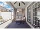 Relaxing screened patio with comfortable seating, table, and ceiling fan at 12306 Ne 48Th Way, Oxford, FL 34484