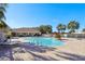 Community pool with ample seating, palm trees, and a clear blue sky background at 12306 Ne 48Th Way, Oxford, FL 34484