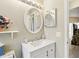 Well-lit bathroom with white vanity and an oval mirror at 1381 Winterville St, Deltona, FL 32725