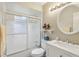 Clean bathroom with white vanity, tub shower combo, and large mirror at 1381 Winterville St, Deltona, FL 32725