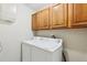 Laundry room with washer, dryer, and overhead cabinets at 1381 Winterville St, Deltona, FL 32725