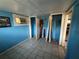 Unfinished basement room with blue walls at 13920 S Highway 25, Eastlake Weir, FL 32133