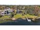 Aerial view of a home and property near the lake at 1535 Sunset Cir, Mount Dora, FL 32757