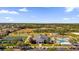 Aerial view of a recreation center with a pool, tennis courts, and a clubhouse within a community at 16967 Se 93Rd Cuthbert Cir, The Villages, FL 32162