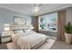 Bedroom featuring a neutral palette, a large window, and a plush rug at 16967 Se 93Rd Cuthbert Cir, The Villages, FL 32162