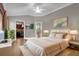 Comfortable main bedroom featuring neutral tones, a ceiling fan, and ample closet space at 16967 Se 93Rd Cuthbert Cir, The Villages, FL 32162