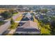 Home's rear elevation, showcasing a screened patio and surrounding landscape at 17030 Se 79Th Clearview Ave, The Villages, FL 32162