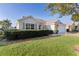 One-story house with a two-car garage and lush landscaping at 17030 Se 79Th Clearview Ave, The Villages, FL 32162