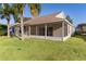 Tan house with screened porch and yard at 17030 Se 79Th Clearview Ave, The Villages, FL 32162