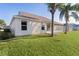 House exterior with green lawn and palm trees at 17030 Se 79Th Clearview Ave, The Villages, FL 32162