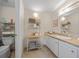 Clean bathroom with white vanity, shelving, and linen storage at 1706 Pebble Beach Ln, Lady Lake, FL 32159