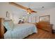 Bright bedroom with wood floors, ceiling fan, and ample closet space at 1706 Pebble Beach Ln, Lady Lake, FL 32159