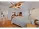 Comfortable bedroom with wood floors, ceiling fan and dresser at 1706 Pebble Beach Ln, Lady Lake, FL 32159