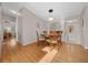 Light-filled dining area with wooden table and chairs, and hardwood floors at 1706 Pebble Beach Ln, Lady Lake, FL 32159