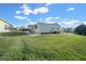 Side view of a white mobile home with a grassy backyard at 1706 Pebble Beach Ln, Lady Lake, FL 32159