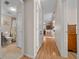 Light hallway with wood floors, leading to bedrooms and bath at 1706 Pebble Beach Ln, Lady Lake, FL 32159