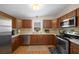 Modern kitchen with stainless steel appliances and wood cabinets at 1706 Pebble Beach Ln, Lady Lake, FL 32159