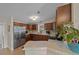 Kitchen with stainless steel appliances and wood cabinets at 1706 Pebble Beach Ln, Lady Lake, FL 32159