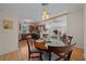 Bright kitchen and dining area with wooden table and chairs, stainless steel appliances, and wood flooring at 1706 Pebble Beach Ln, Lady Lake, FL 32159