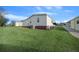 View of home's side, showing exterior and landscaping at 1706 Pebble Beach Ln, Lady Lake, FL 32159