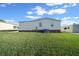 Home's side exterior with landscaping and AC unit at 1706 Pebble Beach Ln, Lady Lake, FL 32159