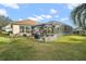 Landscaped backyard with pergola and grill station at 17430 Se 115Th Terrace Rd, Summerfield, FL 34491