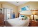 Bright bedroom with a queen-size bed and beach theme at 17430 Se 115Th Terrace Rd, Summerfield, FL 34491