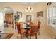 Elegant dining room with a glass-top table and comfortable seating at 17430 Se 115Th Terrace Rd, Summerfield, FL 34491