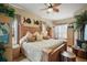 Inviting main bedroom featuring a king-size bed, wood furniture, and coastal decor at 17430 Se 115Th Terrace Rd, Summerfield, FL 34491