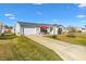 Front view of a single-story house with driveway and lawn at 1842 Captiva Ct, The Villages, FL 32162