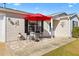 Cozy patio area with red umbrella and outdoor seating at 1842 Captiva Ct, The Villages, FL 32162