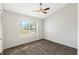 Simple bedroom with large window and ceiling fan at 2121 Croat St, Mount Dora, FL 32757