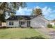 Gray house with a two-car garage and a well-maintained lawn at 2121 Croat St, Mount Dora, FL 32757