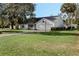 Gray house with a two-car garage and a large yard at 2121 Croat St, Mount Dora, FL 32757