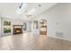 Bright living room with fireplace and vaulted ceiling, kitchen view at 2121 Croat St, Mount Dora, FL 32757