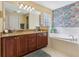 Main bathroom with double vanity and garden tub at 2134 Zaragoza Pl, Lady Lake, FL 32159