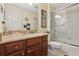 Well-appointed bathroom with granite vanity, shower/tub combo, and updated flooring at 2134 Zaragoza Pl, Lady Lake, FL 32159