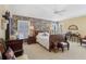 Spacious bedroom with a sleigh bed and floral wallpaper at 2134 Zaragoza Pl, Lady Lake, FL 32159