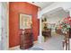 Entryway with view into dining room, featuring decorative console table and rich wall color at 2134 Zaragoza Pl, Lady Lake, FL 32159