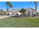 House exterior showcasing a well-maintained lawn and landscaping at 2134 Zaragoza Pl, Lady Lake, FL 32159