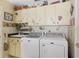 Laundry room with washer, dryer, and painted cabinets at 2134 Zaragoza Pl, Lady Lake, FL 32159