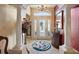 Bright entryway with decorative columns, tiled flooring, and a charming door at 2134 Zaragoza Pl, The Villages, FL 32159