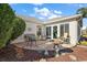 Relaxing patio with seating area, bird bath, and landscaping at 2134 Zaragoza Pl, The Villages, FL 32159