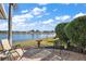 Peaceful patio with lake views, comfortable seating, and bird bath at 2134 Zaragoza Pl, The Villages, FL 32159