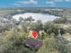 Aerial view of home near lake with lush green landscape at 214 Forest Park Ln, Lady Lake, FL 32159