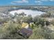 Aerial view of home near lake with lush green landscape at 214 Forest Park Ln, Lady Lake, FL 32159